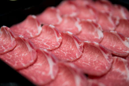 slim slices of raw meatの写真素材