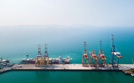 Aerial view of container ship in import - export business industry in Sriracha industrial port,...