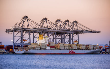 Chonburi, Thailand - February 18, 2018 : Loading cargo container ship port at twilight in Sriracha industrial port, Chonburi, Thailand.のeditorial素材