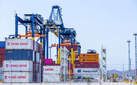 Chonburi, Thailand - February 18, 2018 : Loading cargo container ship port at twilight in Sriracha industrial port, Chonburi, Thailand.のeditorial素材