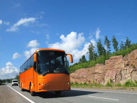 orange tourist bus, highway Scandinaviaの写真素材