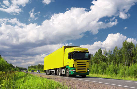 yellow  truck and cars on pictorial highway, polarized landscapeの写真素材