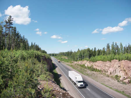 white tuck on highway and rocky landscapeの写真素材