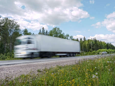 white truck speeding on country highway, blured in motionの写真素材