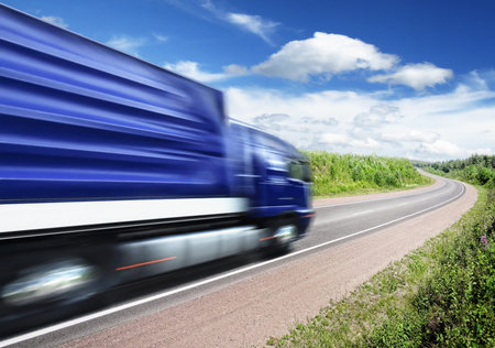 blue truck speeding on country highway, motion blurの写真素材