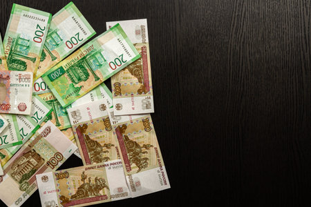 much russian money paper rubles lying on the black wooden table