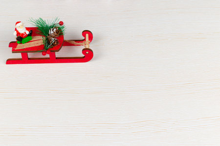 santa claus on a sleigh carries gifts on a white wood background with gold veins