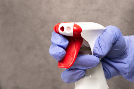 white bottle with a spray bottle and a red button with window and glass cleanerの写真素材