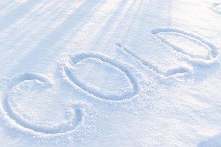 inscription on pure white snow on a frosty winter sunny day. close-up. russiaの写真素材