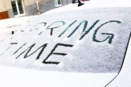the inscription on the snow-covered rear window of the car spring time on a bright sunny day. close-upの写真素材