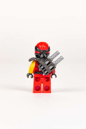 Yekaterinburg. Russia. 04.08.2021. Toy hero Kai in a red kimono with a sword from a set of lego ninjago on a white background. close-up. selective focusのeditorial素材