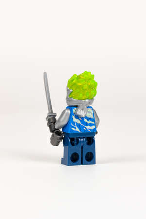 Yekaterinburg. Russia. 04.08.2021. Toy hero Jay in a blue kimono with a sword from a set of lego ninjago on a white background. close-up. selective focusのeditorial素材