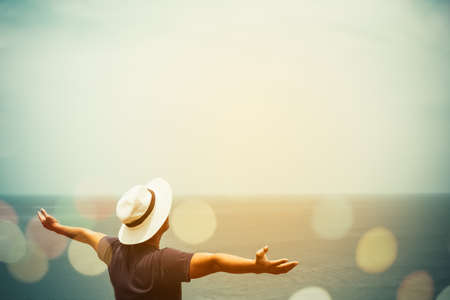 Man rise hands up to sky freedom concept with blue sky and summer ocean background.の写真素材