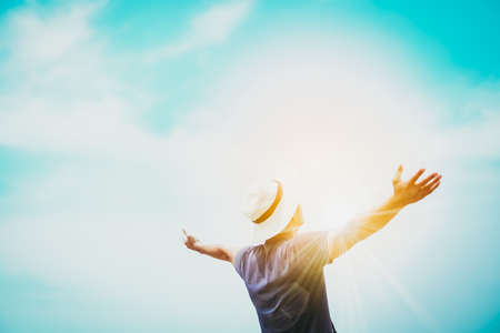 Man rise hands up to sky freedom concept with blue sky and summer ocean background.の写真素材