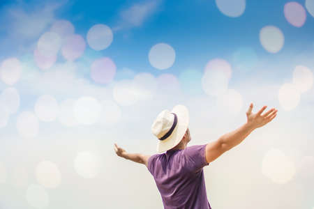 Man rise hands up to sky freedom concept with blue sky and summer ocean background.の写真素材