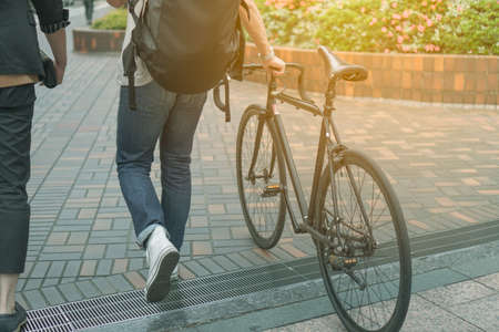 Man walking with bicycle on path way with sunlight vintage color tone style backgroundの写真素材