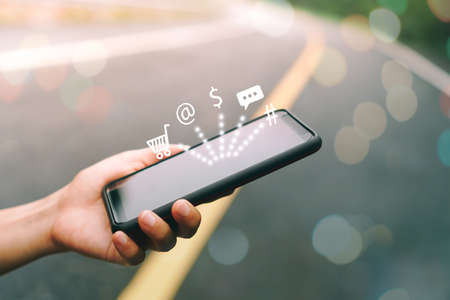 Women hand using smartphone do online selling for people shopping online with chat box, cart, dollar icons pop up. Social media maketing concept.の写真素材