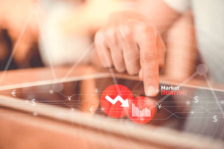 Woman hand using smartphone or tablet to do business, financial or trading stock exchange currency in forex market in bearish situation falling down  with cafe bokeh vintage color tone background.Technology freedom life style concept.の写真素材