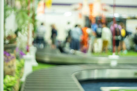 Blur hall of traveller waiting for their luggage at airport baggage.の写真素材