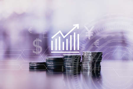 Business financial success concept with currency icon and graph double expose on picture. Gold coins on table and green nature bokeh background.Bullish market situation.の写真素材