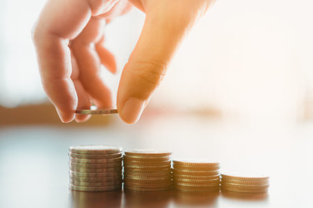 Business financial success concept. Gold coins on table and green nature bokeh background.の写真素材
