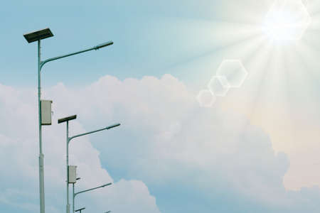 Public Electricity light power from slor cell with summer blue sky, white cloud and light flare from sun abstract background.の写真素材