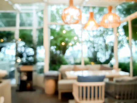 Blur coffee cafe with customers background vintage tone color style.の写真素材