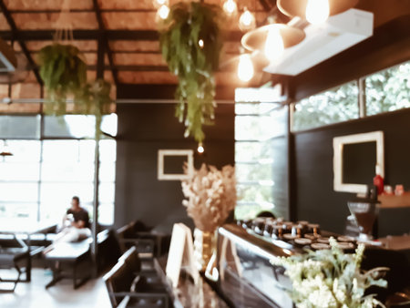 Blur coffee cafe with customers background vintage tone color style.の写真素材