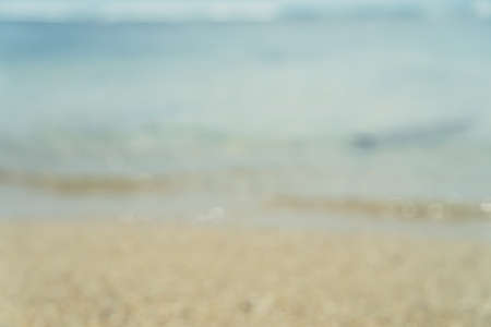 Blur beach wave and sand with bokeh summer color background.の写真素材