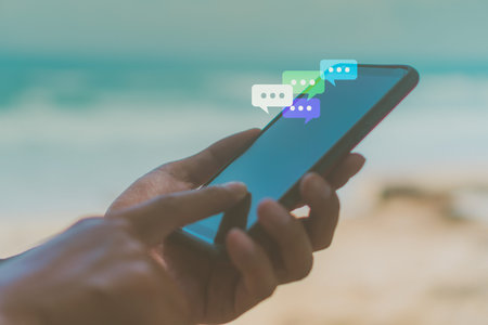 Women hand using smartphone typing, chatting conversation in chat box icons pop up.