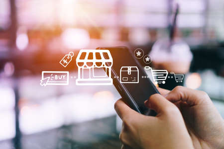 Women hand using smartphone do online selling for people shopping online with chat box, cart, dollar icons pop up. Social media maketing concept.の写真素材