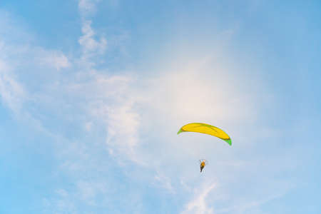 Man is riding para motor in beautiful  sunset cloud sky background.の写真素材