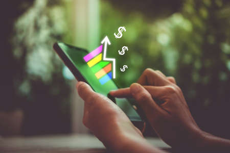 Market stock graph icon screen of smartphone background. Financial business technology freedom dream life using internet freedom life concept.の写真素材
