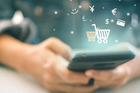 Women hand using smartphone do online selling for people shopping online with chat box, cart, dollar icons pop up. Social media maketing concept.の写真素材