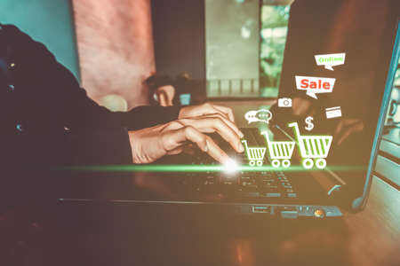 Women hand using laptop do online selling for people shopping online with chat box, cart, dollar icons pop up. Social media maketing concept.の写真素材