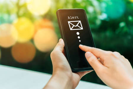 Woman hand using smartphone to send and recieve email. Business communication  technology concept.の写真素材