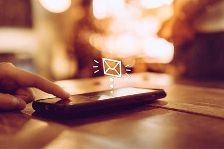 Woman hand using smartphone to send and recieve email. Business communication  technology concept.の写真素材