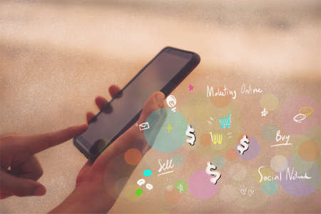 Women hand using smartphone do online shopping for cloths with chat box, cart, dollar cloth doodle pop up. Social media maketing concept.の写真素材