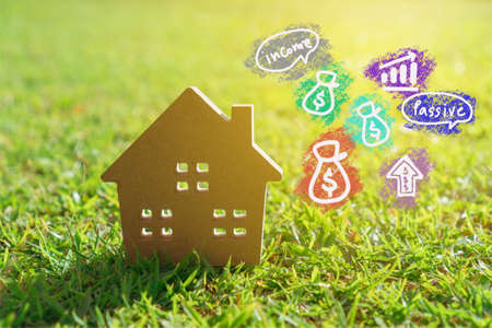 Buy sell icon screen on model of a little house  with nature green background. Dream life concept.の写真素材