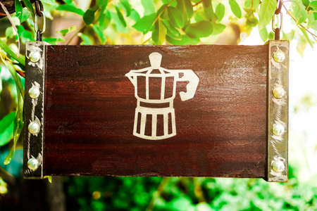 Wood sign board vitage style hang from tree in front of coffee shop.の写真素材