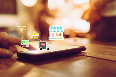 Women hand using smartphone do shopping online store with various doodle icons pop up. Social media maketing concept.の写真素材