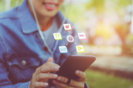 Mix icon travel vacation holiday icons mixed screen on woman hand using smartphone to plan for long weekend.の写真素材
