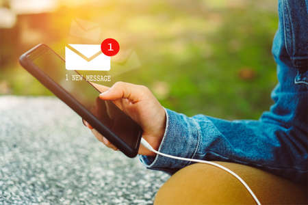 Woman hand using smartphone got 1 new message email. Business communication  technology concept.の写真素材