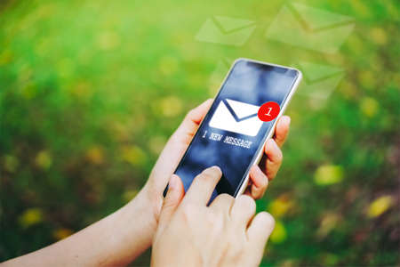 Woman hand using smartphone got 1 new message email. Business communication  technology concept.の写真素材