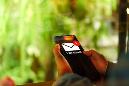 Woman hand using smartphone got 1 new message email. Business communication  technology concept.の写真素材