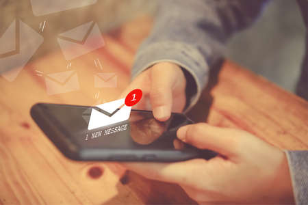 Woman hand using smartphone got 1 new message email. Business communication  technology concept.の写真素材