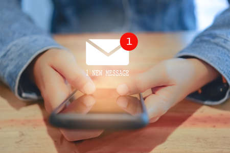Woman hand using smartphone got 1 new message email. Business communication  technology concept.の写真素材