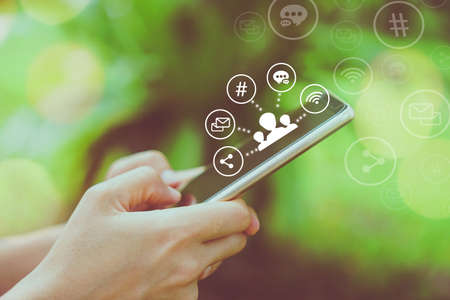 Communication fintech sign icon and connection screen of smartphone with blur cafe coffee shop background. Financial business technology freedom dream life using internet freedom life concept.の写真素材