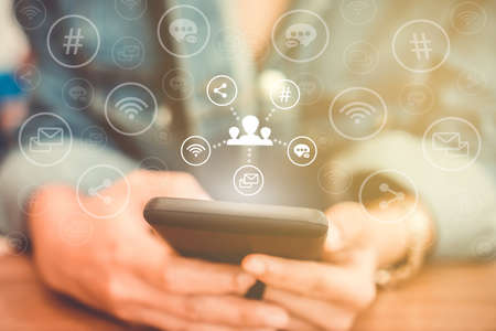 Communication fintech sign icon and connection screen of smartphone with blur cafe coffee shop background. Financial business technology freedom dream life using internet freedom life concept.の写真素材