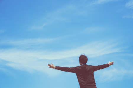 Man rise hands up to sky freedom concept with blue sky and summer background.の写真素材